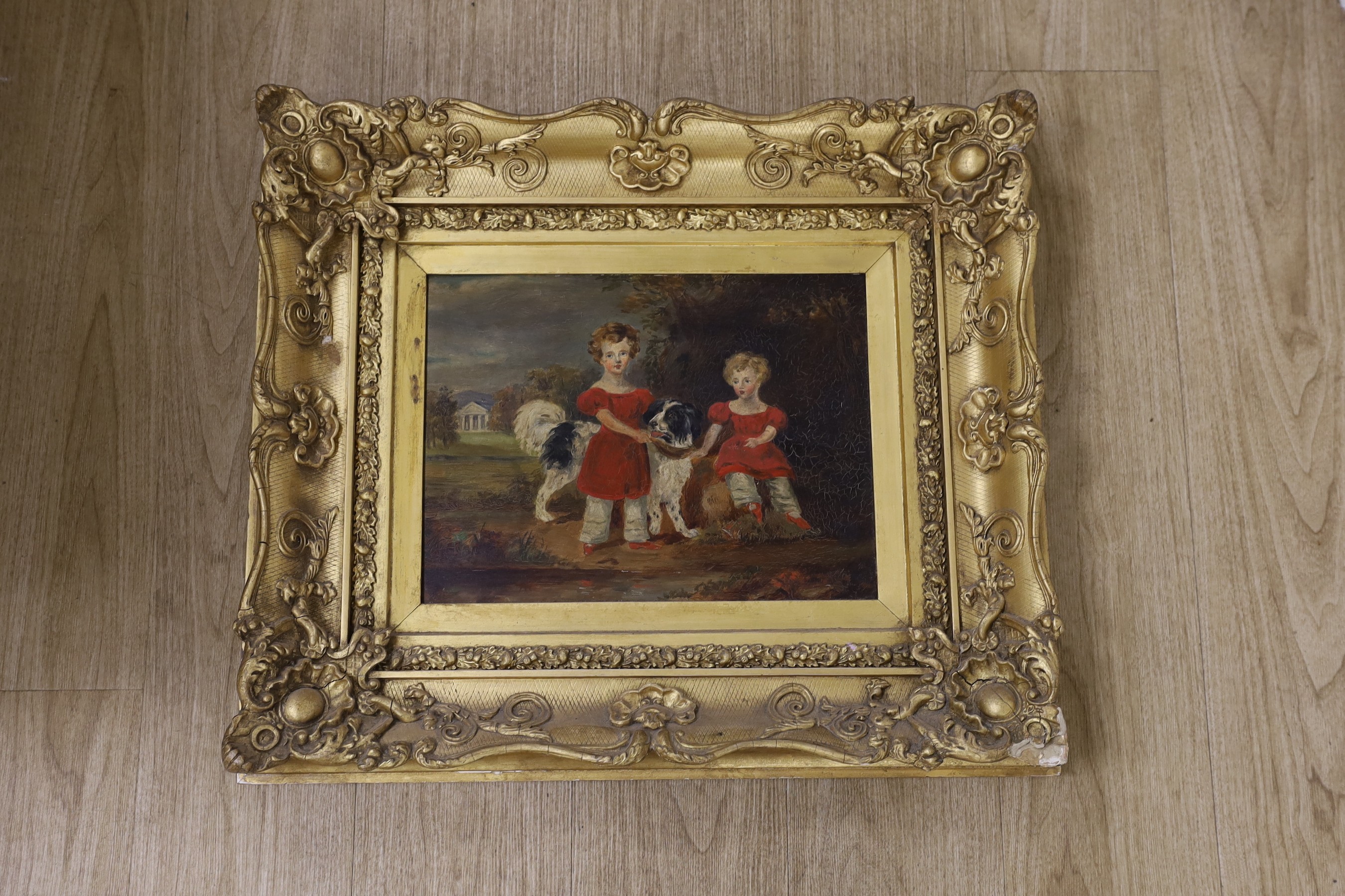 Victorian School, oil on board, Two children with a spaniel, possibly an overpainted print, 29 x 38cm